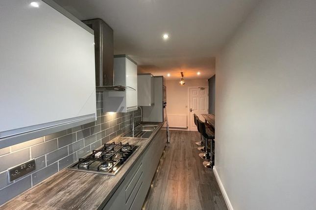 A Modern Galley Kitchen With Sleek Cabinetry, A Ga...