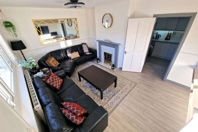 A Stylish And Inviting Living Room Featuring A Lar...