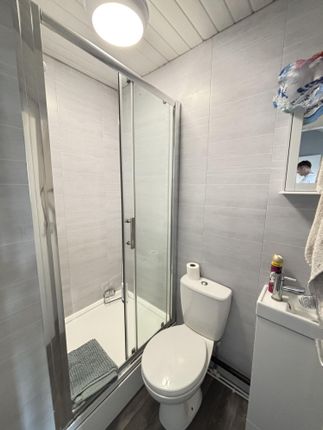 A Clean And Functional Bathroom Featuring A Shower...