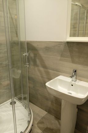 A Modern Bathroom Featuring A Sleek Corner Shower ...
