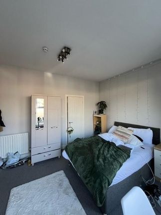 A Spacious And Inviting Master Bedroom Featuring A...