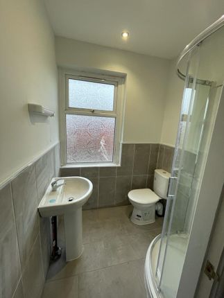 A Modern Bathroom Featuring A Curved Glass Shower ...