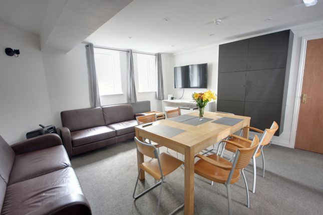 A Spacious And Stylish Living Room Perfect For Soc...