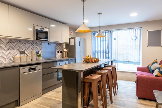 Bright, Modern Kitchen With A Central Island Break...