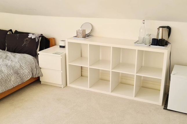 Cozy And Tidy Bedroom Featuring A Comfortable Sing...