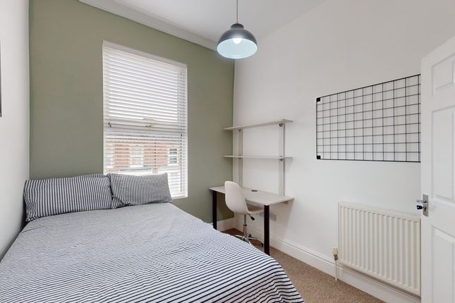 A Bright And Tidy Double Bedroom Featuring A Comfo...