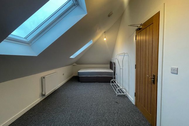 This Spacious Double Bedroom Features A Large Wind...