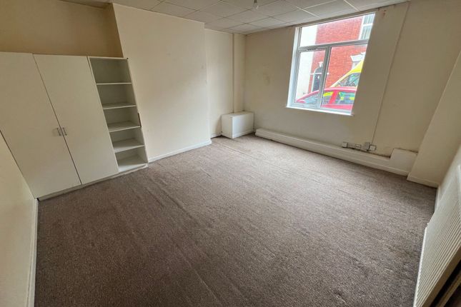 A Simple, Unfurnished Single Bedroom Featuring A l...