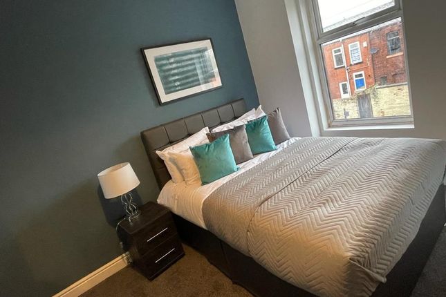 A Cozy Double Bedroom Featuring A Comfortable Doub...