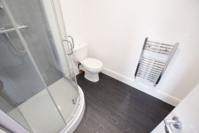 A Modern And Clean Bathroom Featuring A Shower And...
