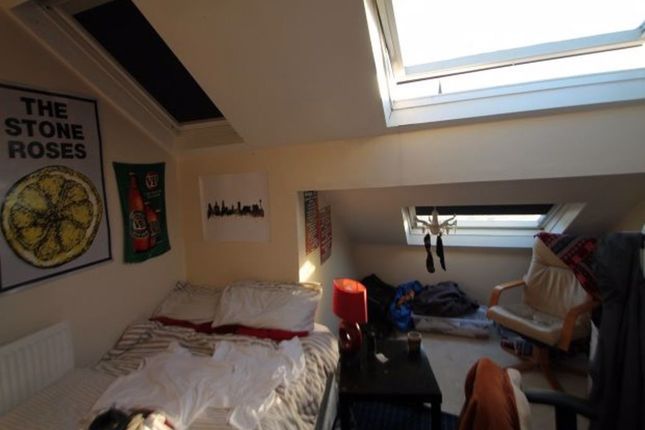 Cozy Attic Bedroom Featuring A Sloped Ceiling With...