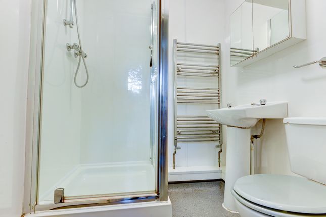 A Bright And Clean Bathroom Featuring A Modern Sho...