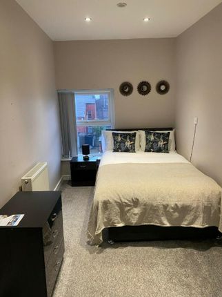 A Stylish And Inviting Double Bedroom With Ample N...