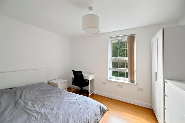 A Spacious And Bright Bedroom Featuring A Comforta...