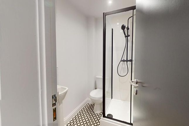 A Modern And Clean Bathroom Featuring A Stylish Sh...