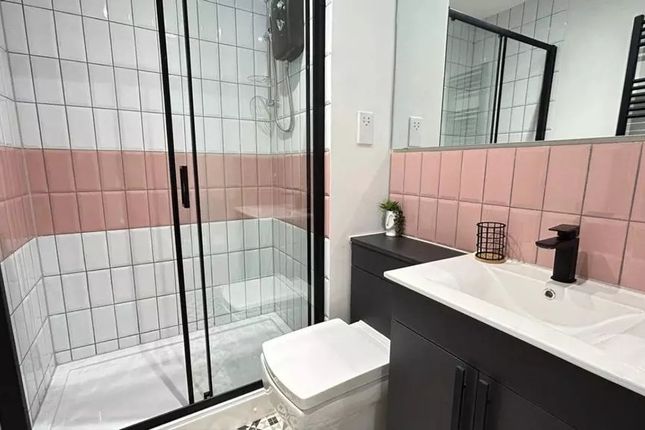 A Modern And Stylish Bathroom Featuring A Spacious...