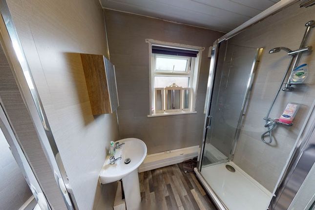 Bright And Clean Bathroom Featuring A Shower Enclo...