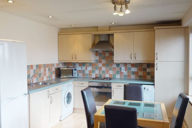 Bright And Modern Kitchen Featuring A Tiled Backsp...