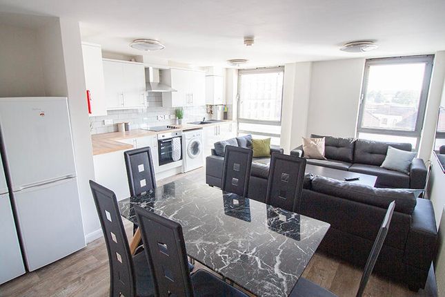A Spacious And Modern Living Room Featuring A Styl...