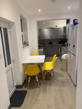 Bright Modern Galley Kitchen With A Compact Dining...