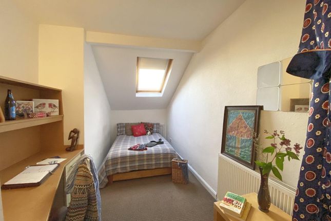 Cozy Single Bedroom With A Comfortable Bed Beneath...