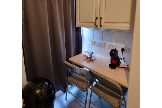 A Cozy Kitchenette With Essential Appliances, Perf...