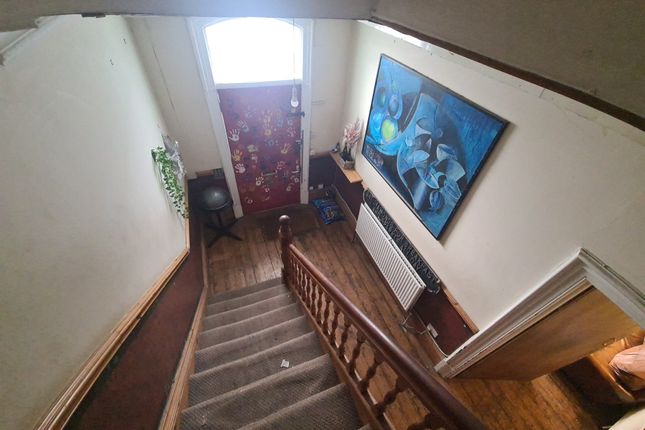 A Cozy Hallway Featuring A Carpeted Staircase With...