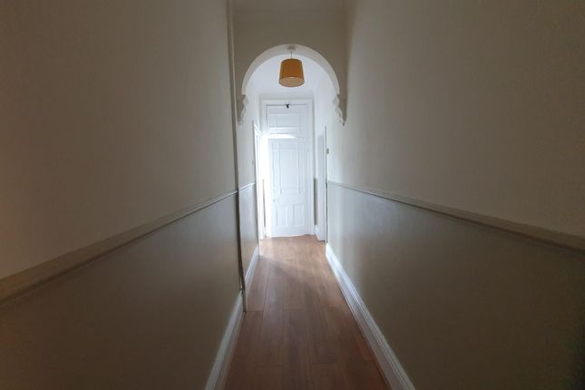 A Clean And Simple Hallway With Wooden Flooring An...
