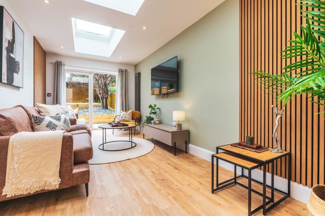 A Spacious And Modern Living Room Filled With Natu...