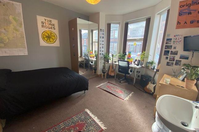 A Spacious And Well-Lit Living Room With Large Win...