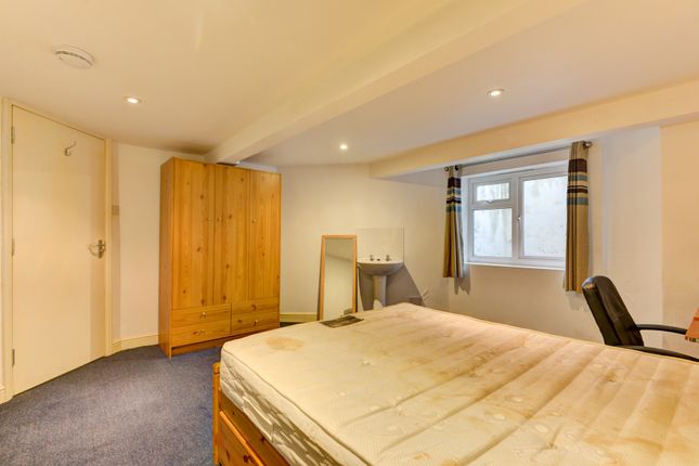 A Cozy Bedroom Featuring A Double Bed, A Window Wi...