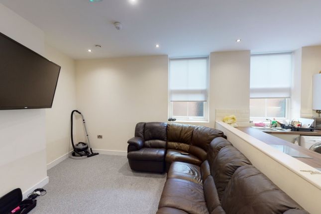 A Cozy Living Room Featuring A Large Brown Leather...