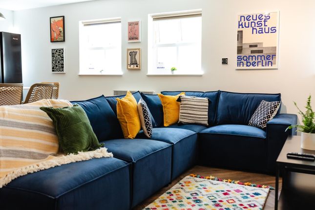 Bright, Stylish Living Room With A Large Navy Sect...