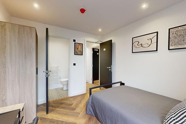 A Bright And Tidy Single Bedroom Featuring A Comfo...