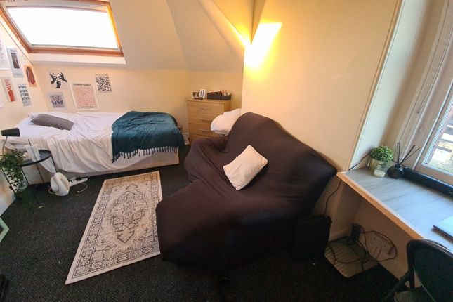 Cozy Single Bedroom Featuring A Comfortable Bed Po...