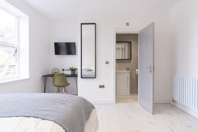 A Bright And Tidy Bedroom Featuring Natural Light ...