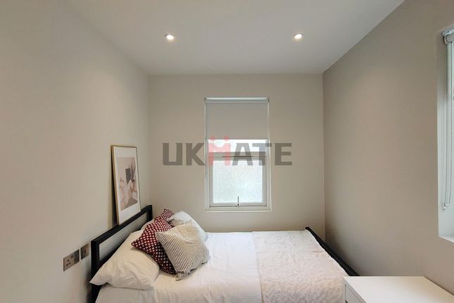 A Bright And Tidy Bedroom Featuring A Neatly Made ...