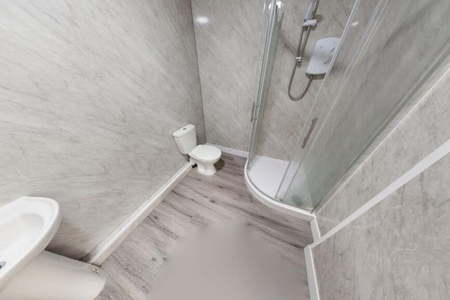 Compact Bathroom Featuring A Modern Corner Shower ...