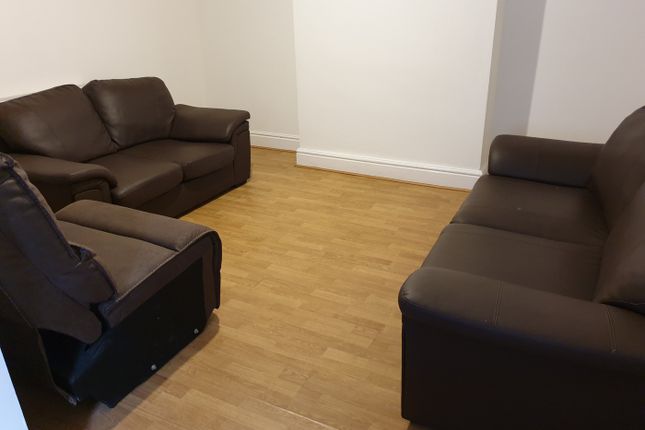A Cozy Living Room Featuring Comfortable Brown Lea...
