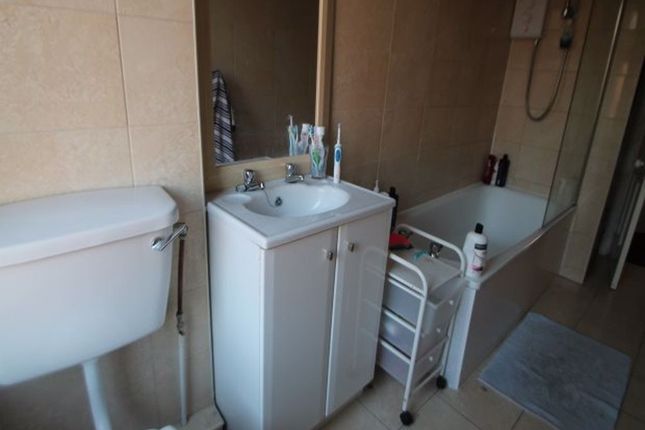 A Well-Maintained Bathroom Featuring A Toilet, A S...