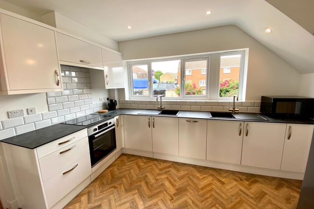 A Bright And Modern Kitchen Featuring Sleek Cabine...