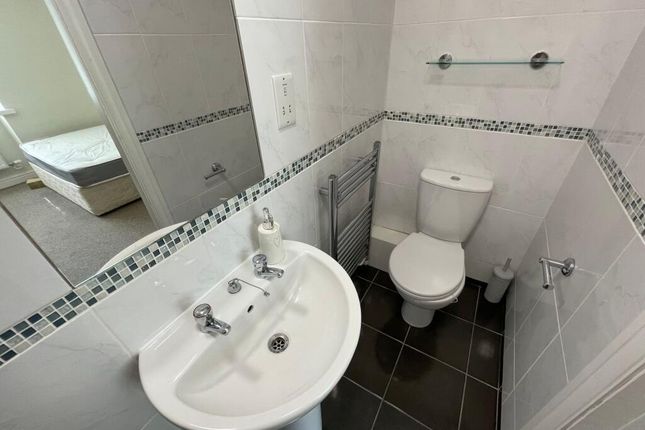 A Clean And Tidy Small Bathroom Featuring White Ti...