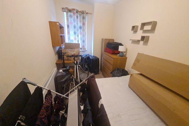 Cozy Single Bedroom Featuring A Neatly Made Bed, A...