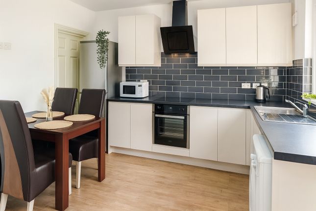 Bright And Modern Kitchen Featuring Sleek Cabinetr...
