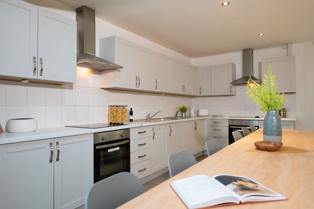A Bright And Spacious Kitchen Featuring Modern App...