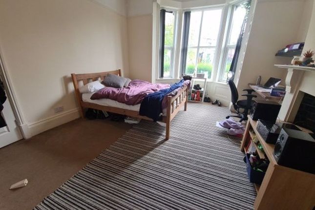 A Cozy Single Bedroom With A Large Bay Window Allo...