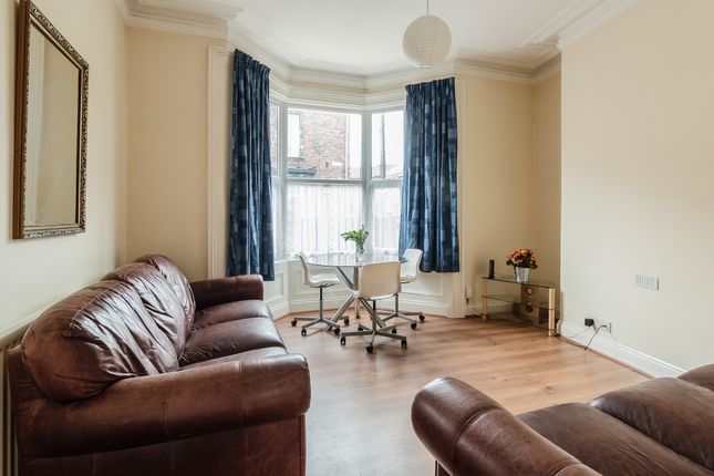 A Bright And Inviting Living Room Featuring Comfor...