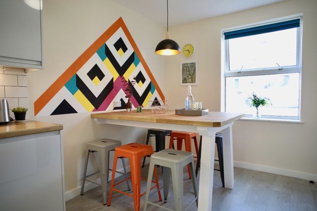 A Vibrant Kitchen Featuring A Modern Design With c...