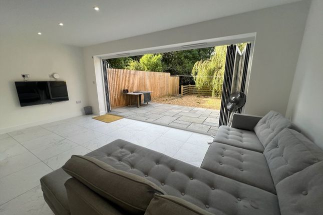 Bright And Spacious Living Room Featuring Large Bi...