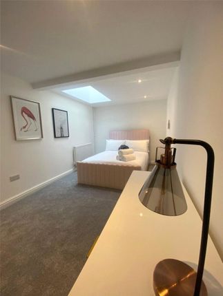 A Bright And Modern Master Bedroom Featuring A Com...